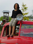 Claire sitting on the fire truck cab at Remlinger Farms.