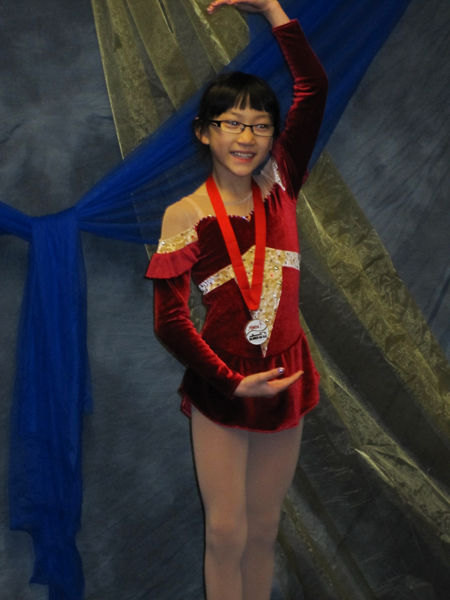 Claire and her silver medal from Blades On Ice at Highland Ice Arena ins Seattle.